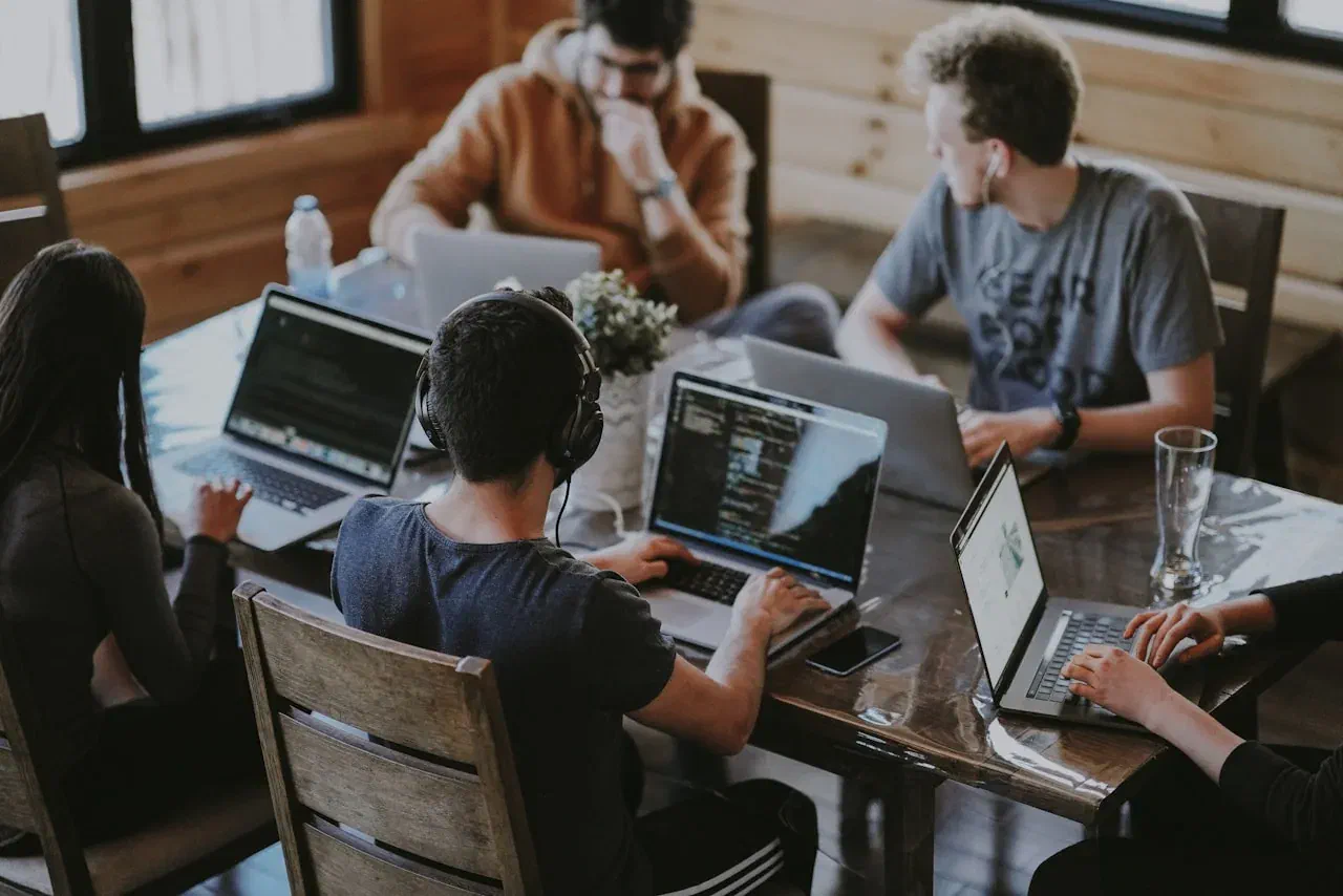 Team gathered around a laptop, planning together